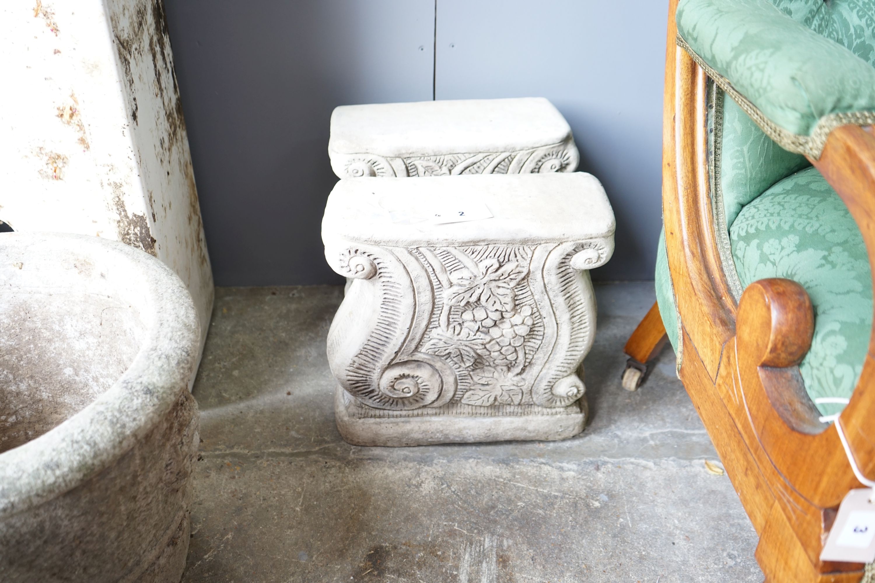A pair of circular reconstituted stone garden planters, diameter 42cm together with a pair of stone bench supports